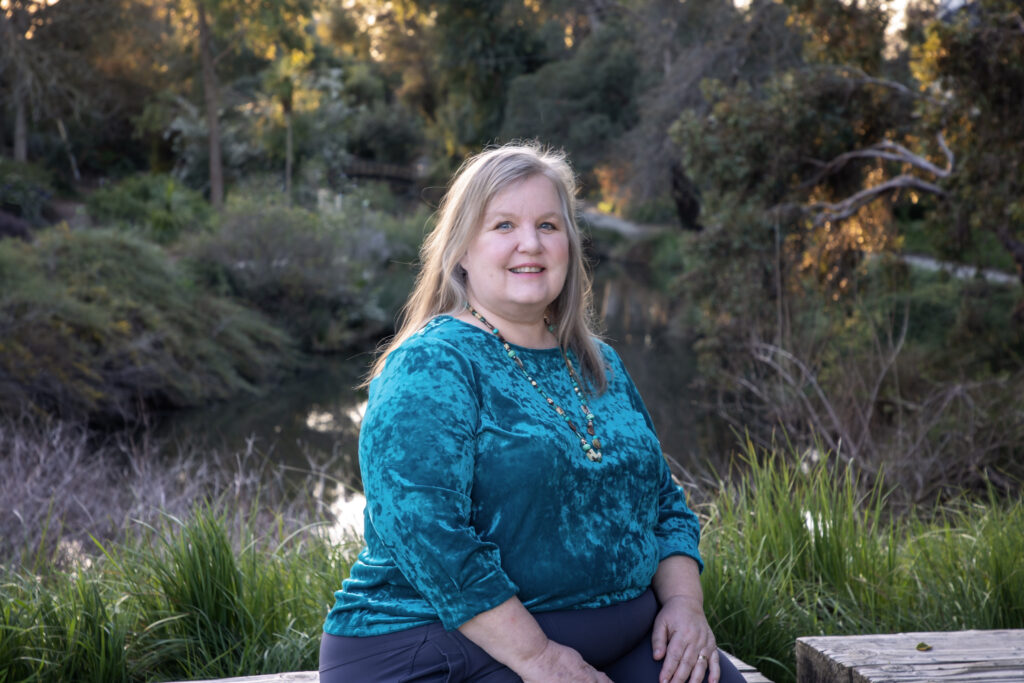 tutor and reading specialist Sarah Foley sitting and smiling in nature